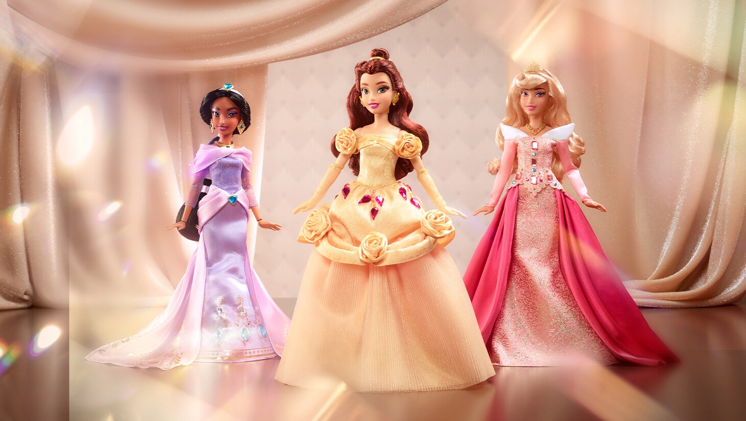 Image of Jasmine, Belle, and Aurora dolls from the Mattel Radiance Collection.