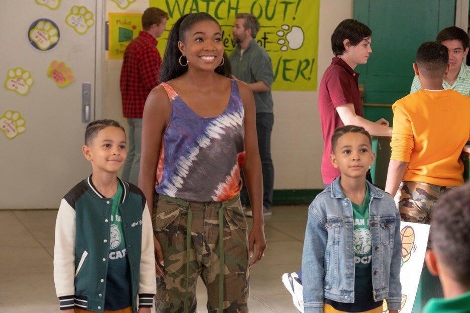 Mom (Gabrielle Union) smiles at school with the twins in Disney+'s Cheaper By the Dozen