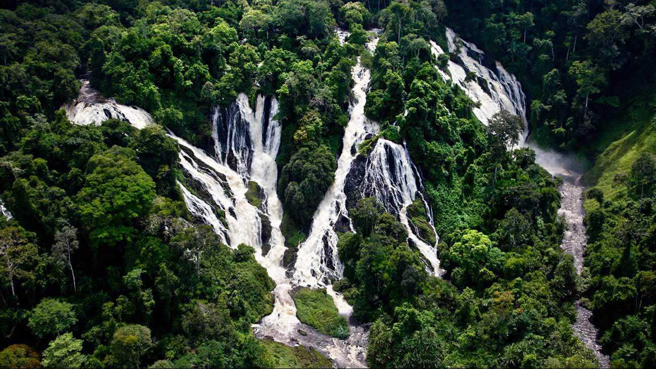 Majestic waterfalls pouring down a lush jungle mountain