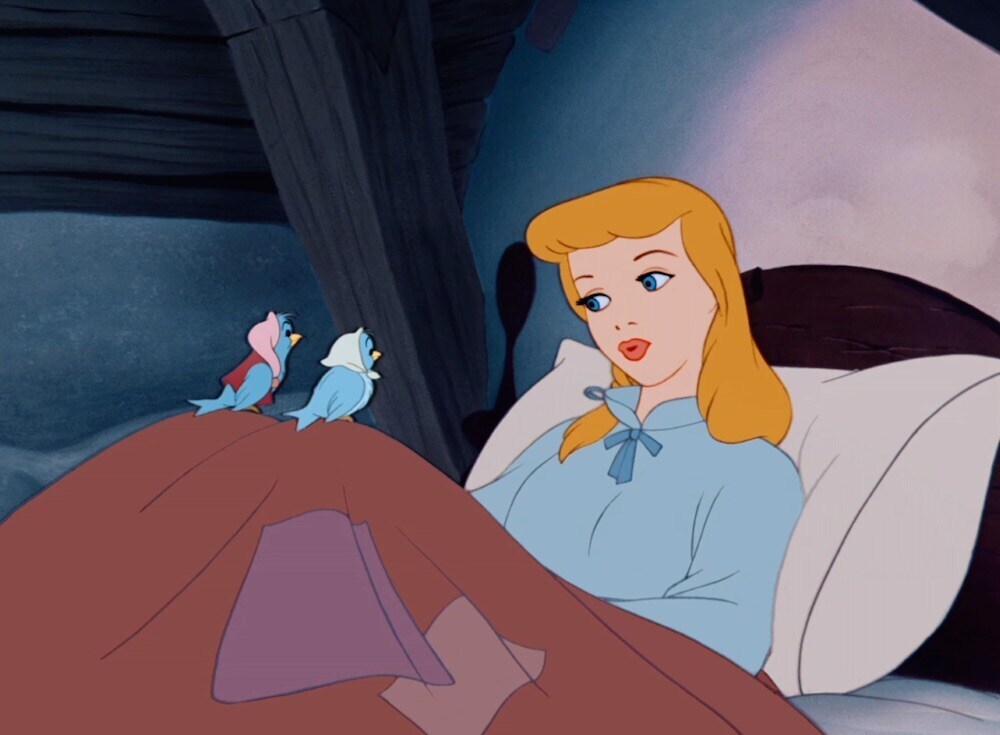 Animated character Cinderella with birds on her knees from the film "Cinderella