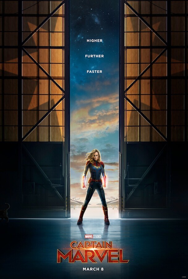 Marvel Studios Captain Marvel March 8 Captain marvel in front of a hangar, hands glowing with cosmic power