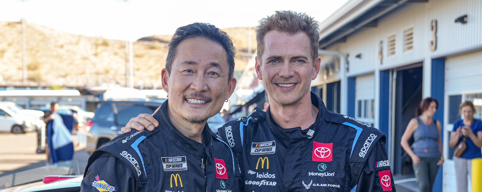 Doug Chiang and Hayden Christensen in NASCAR racing suits.