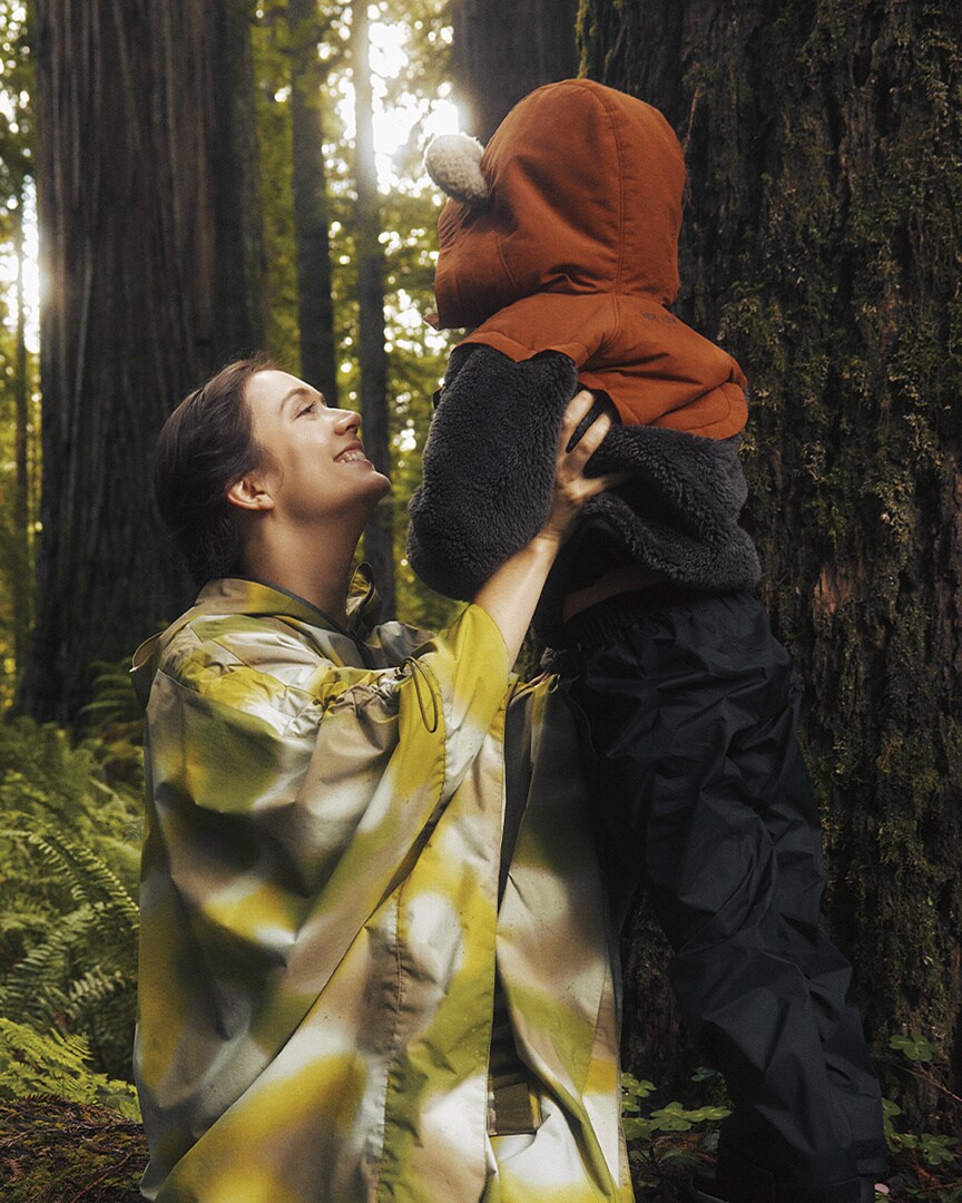 Billie Lourd, left, recreates a scene from Star Wars: Return of the Jedi in the Endor Issue Poncho from Columbia's new Endor Star Wars collection.