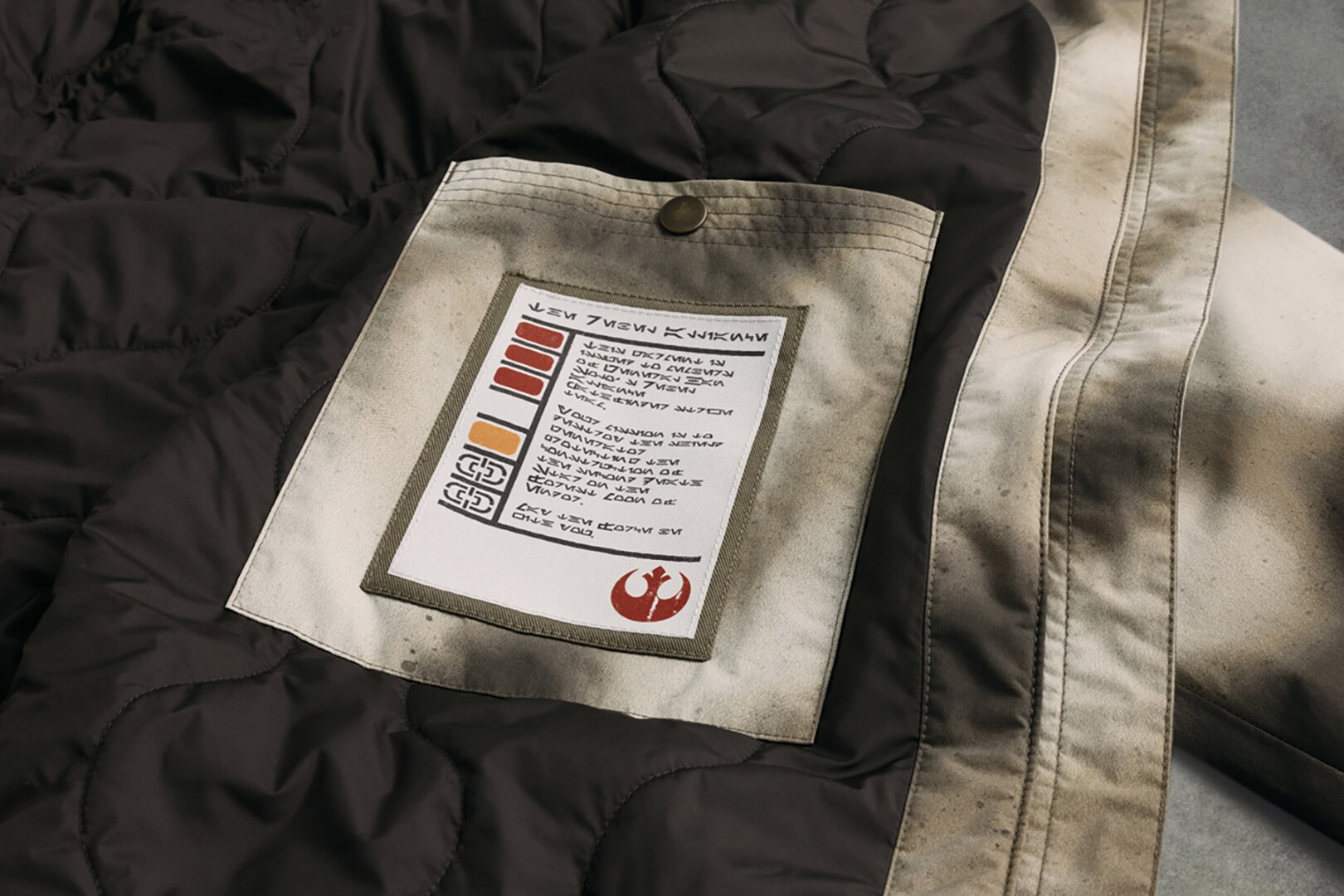 A Rebel Alliance badge in the Endor Issue Poncho from Columbia's Endor-Inspired Star Wars Collection.