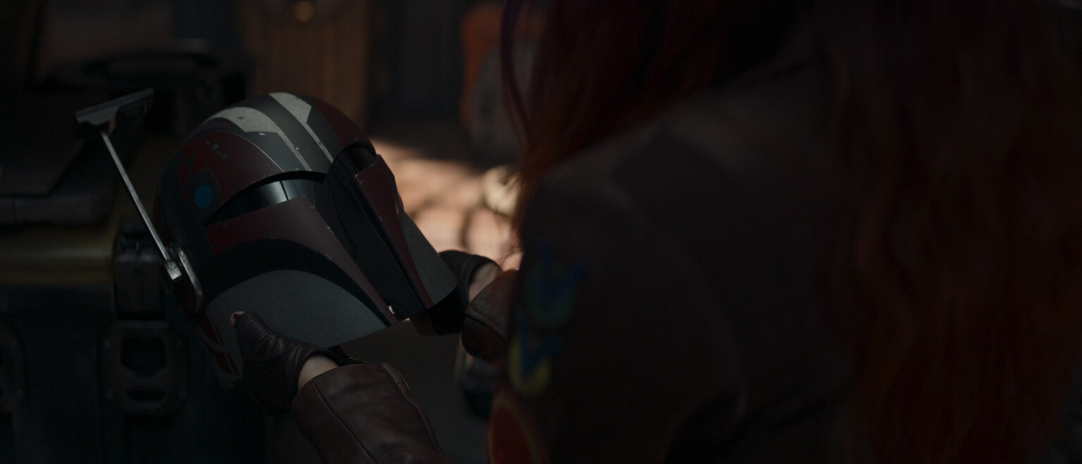 Sabine Wren looks at her helmet.
