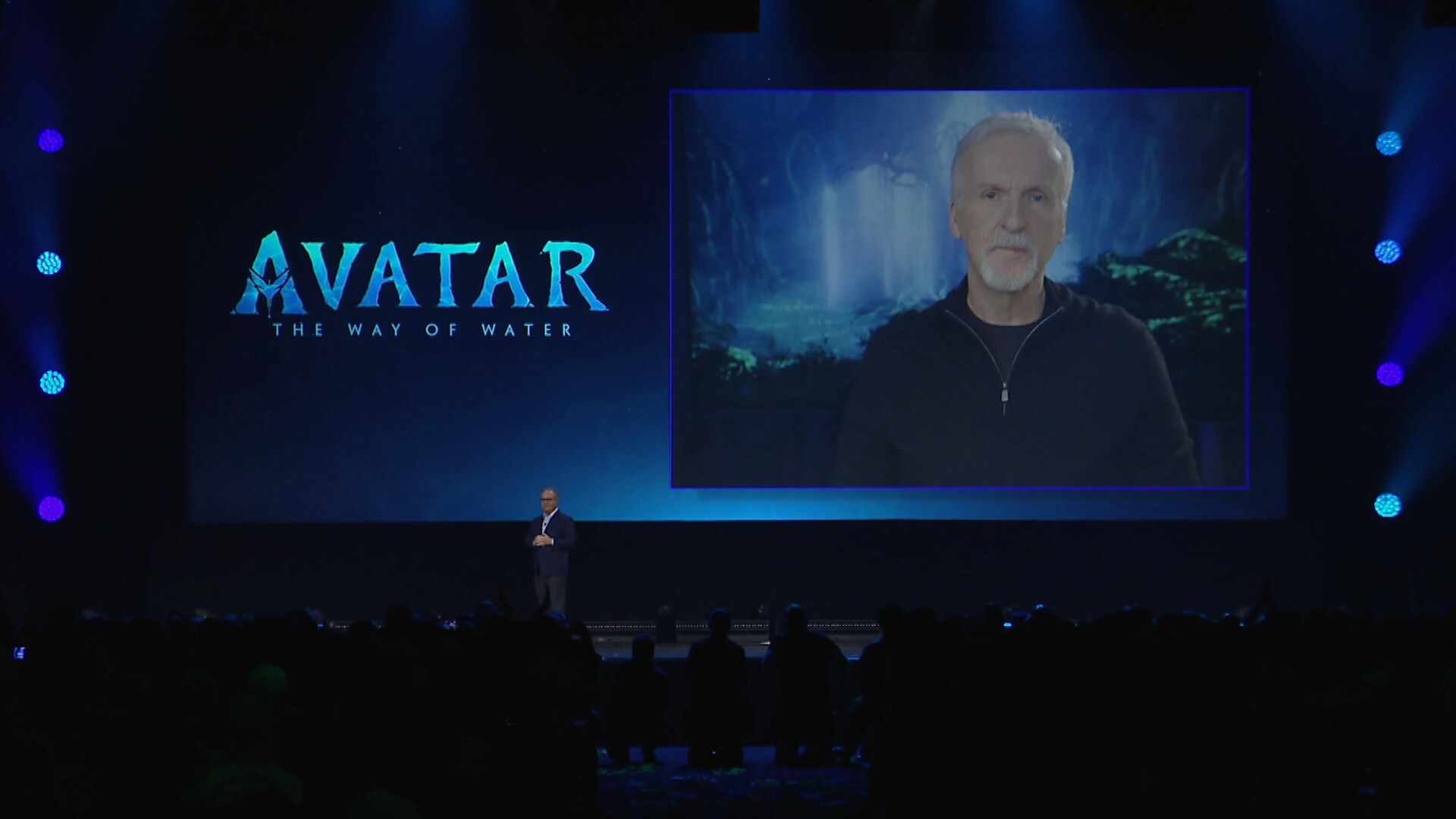 James Cameron on a large video screen with the title "Avatar: The Way of Water".