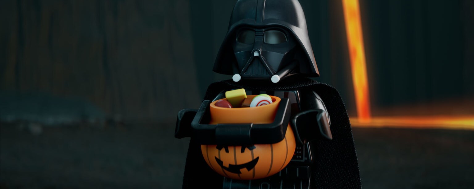 Darth Vader holding a Halloween bucket filled with candy in a LEGO Star Wars short.