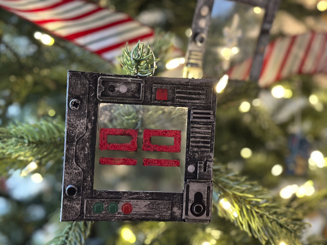 A complete datapad ornament hanging on a tree.
