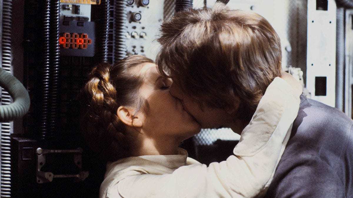 Princess Leia kissing Han Solo on the Millennium Falcon