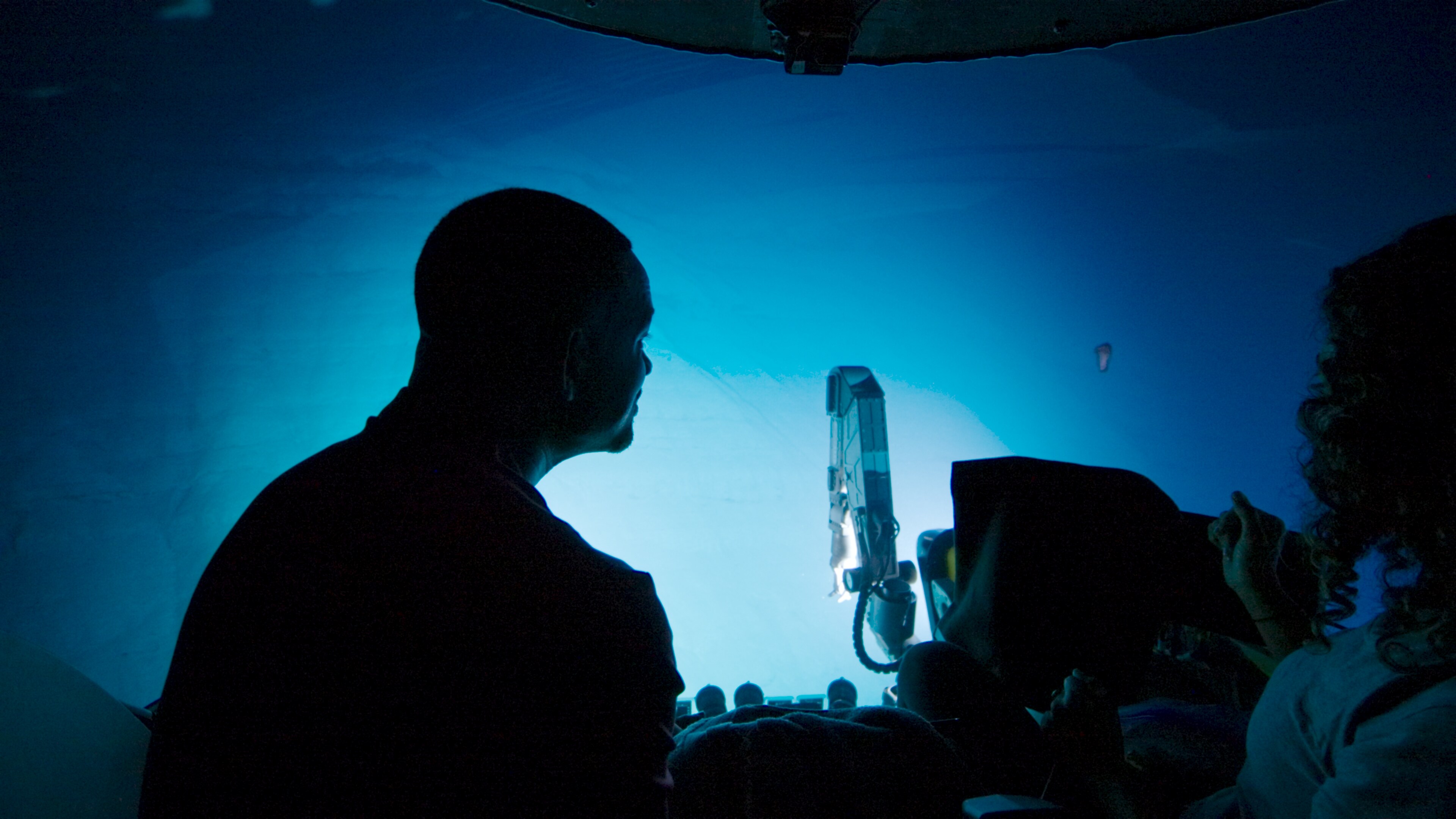 Will Smith observes an Enypniastes Eximia (swimming sea cucumber) from the Nadir submarine deep beneath the waves of the Atlantic Ocean.  (National Geographic for Disney+)