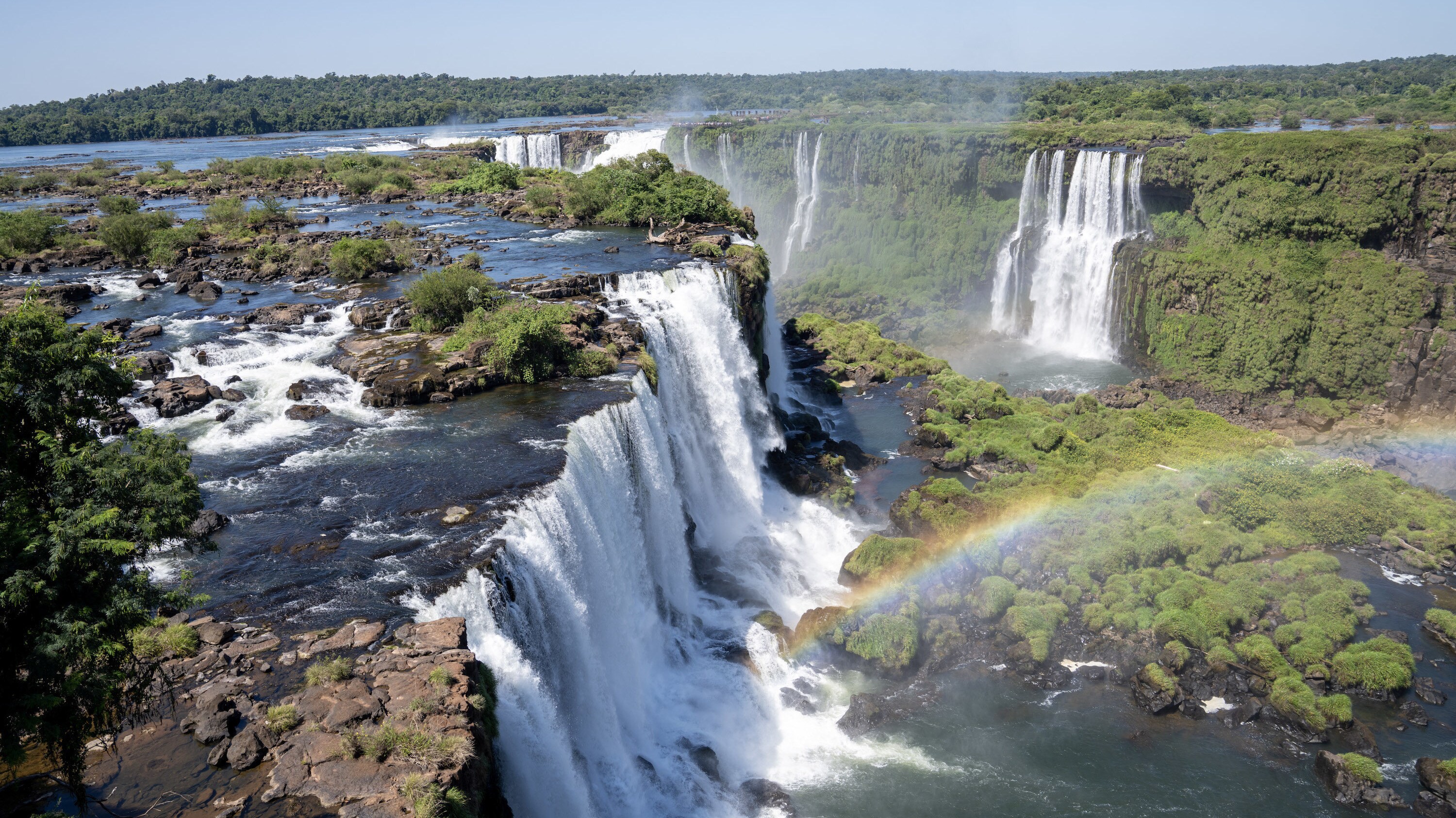 View of the Iguaçu falls. The name 'Iguaçu' comes from the Tupi-Guaraní words "y", meaning "water", and 'ûasú', meaning "big". Legend has it that a deity planned to marry a beautiful woman named Naipí, who fled with her mortal lover Tarobá in a canoe. In a rage, the deity sliced the river, creating the waterfalls and condemning the lovers to an eternal fall.  (National Geographic for Disney+/Lea Hejn)