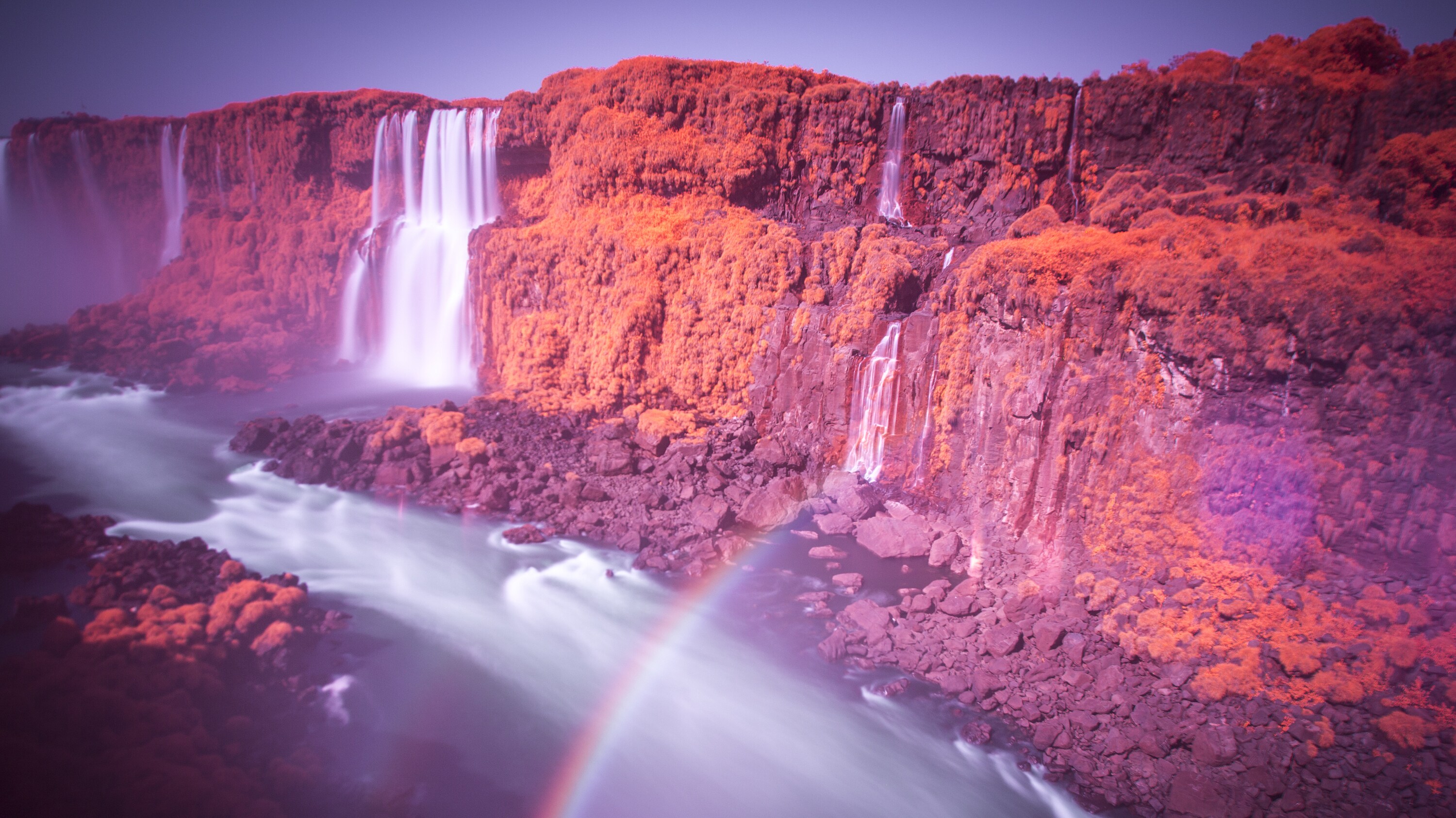 The Iguaçu Falls photographed with an infrared filter, revealing 'color' that is invisible to us.  (National Geographic for Disney+/Freddie Claire)