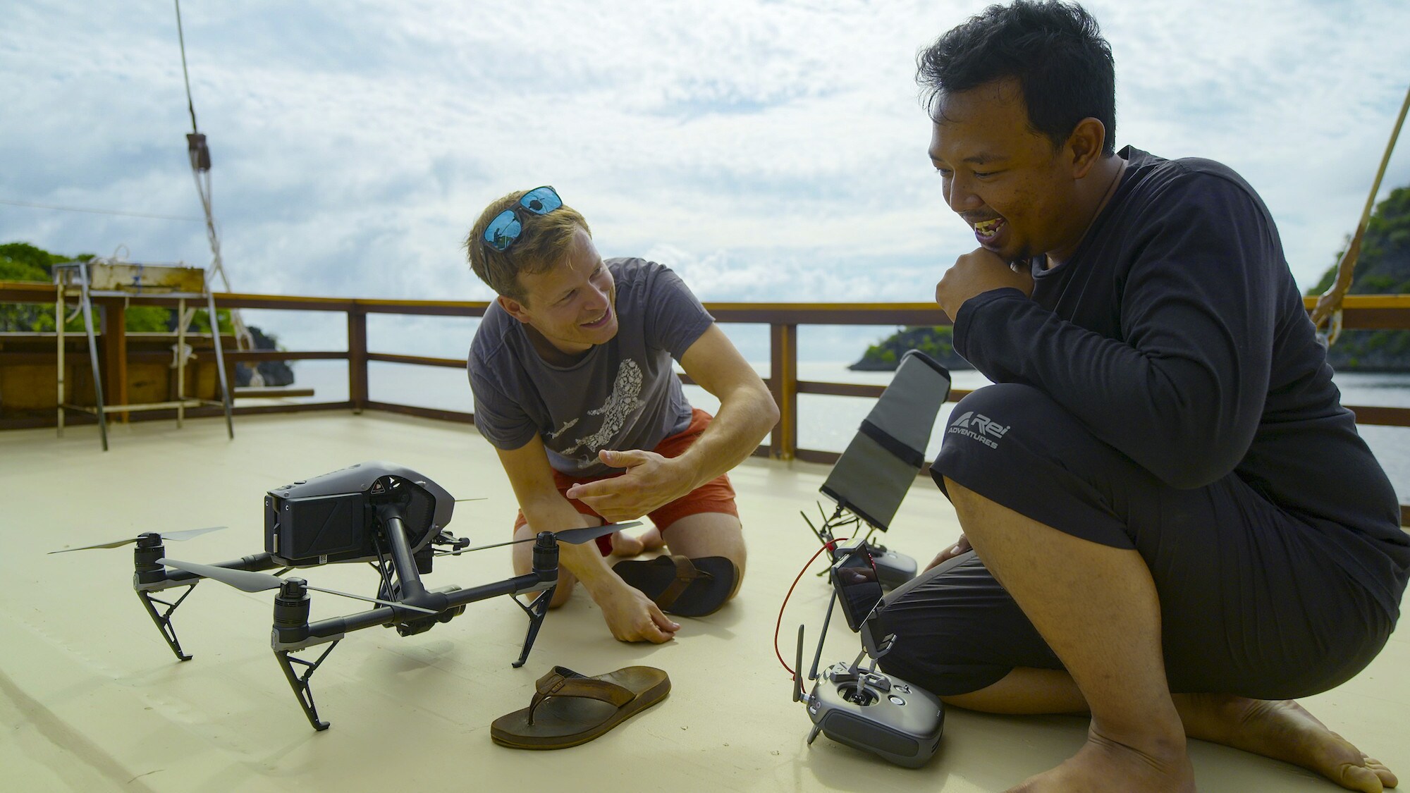Bertie Gregory and Ferdy Anggriya Suwartana talk through drone instructions. (National Geographic for Disney+/Spencer Millsap)