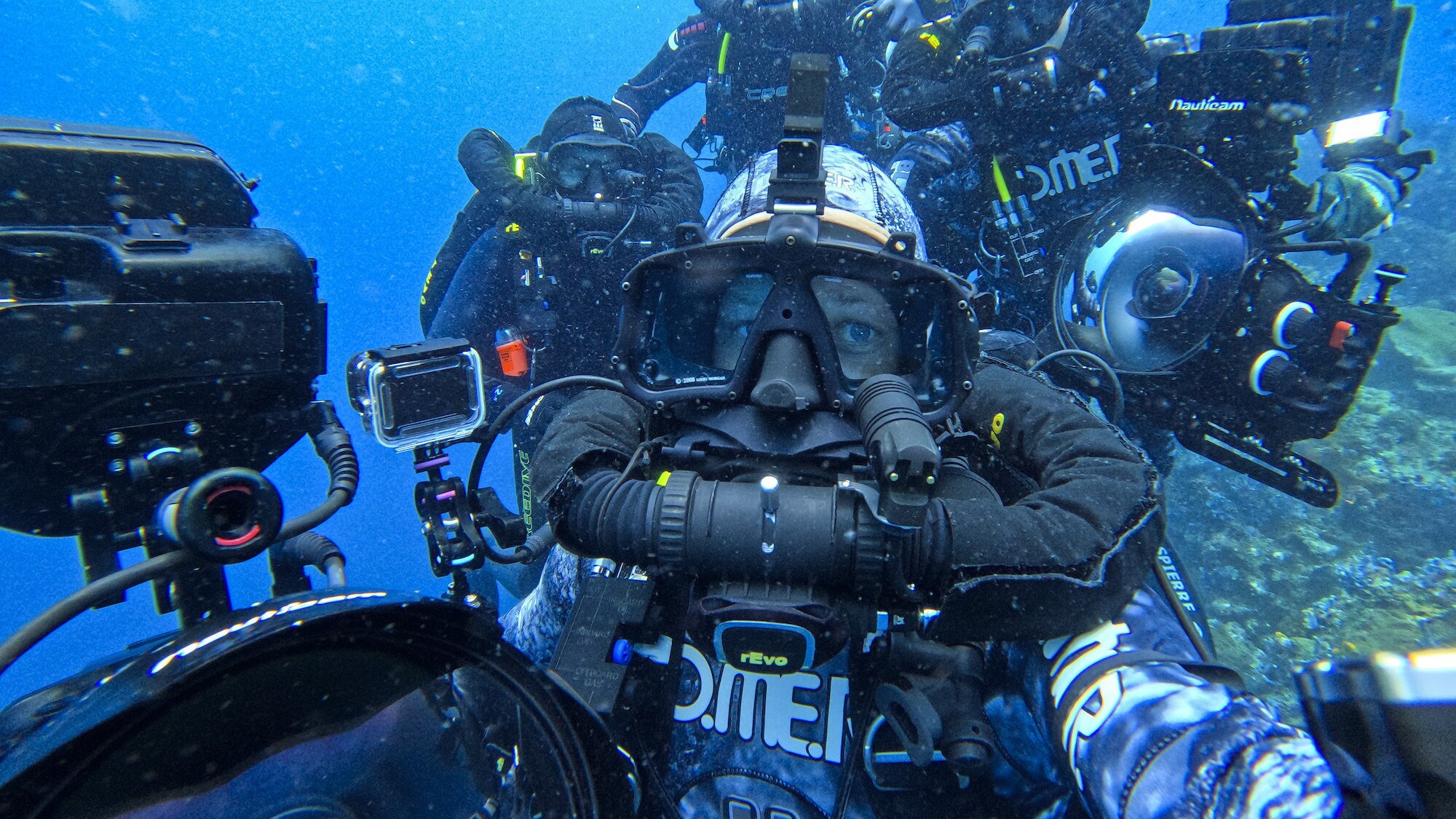 Bertie Gregory surrounded by the crew underwater. (National Geographic for Disney+/Bertie Gregory)