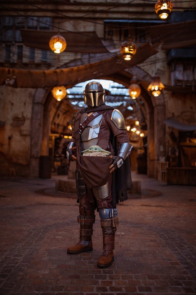 Mando and Grogu at Star Wars: Galaxy’s Edge at Disneyland Park.
