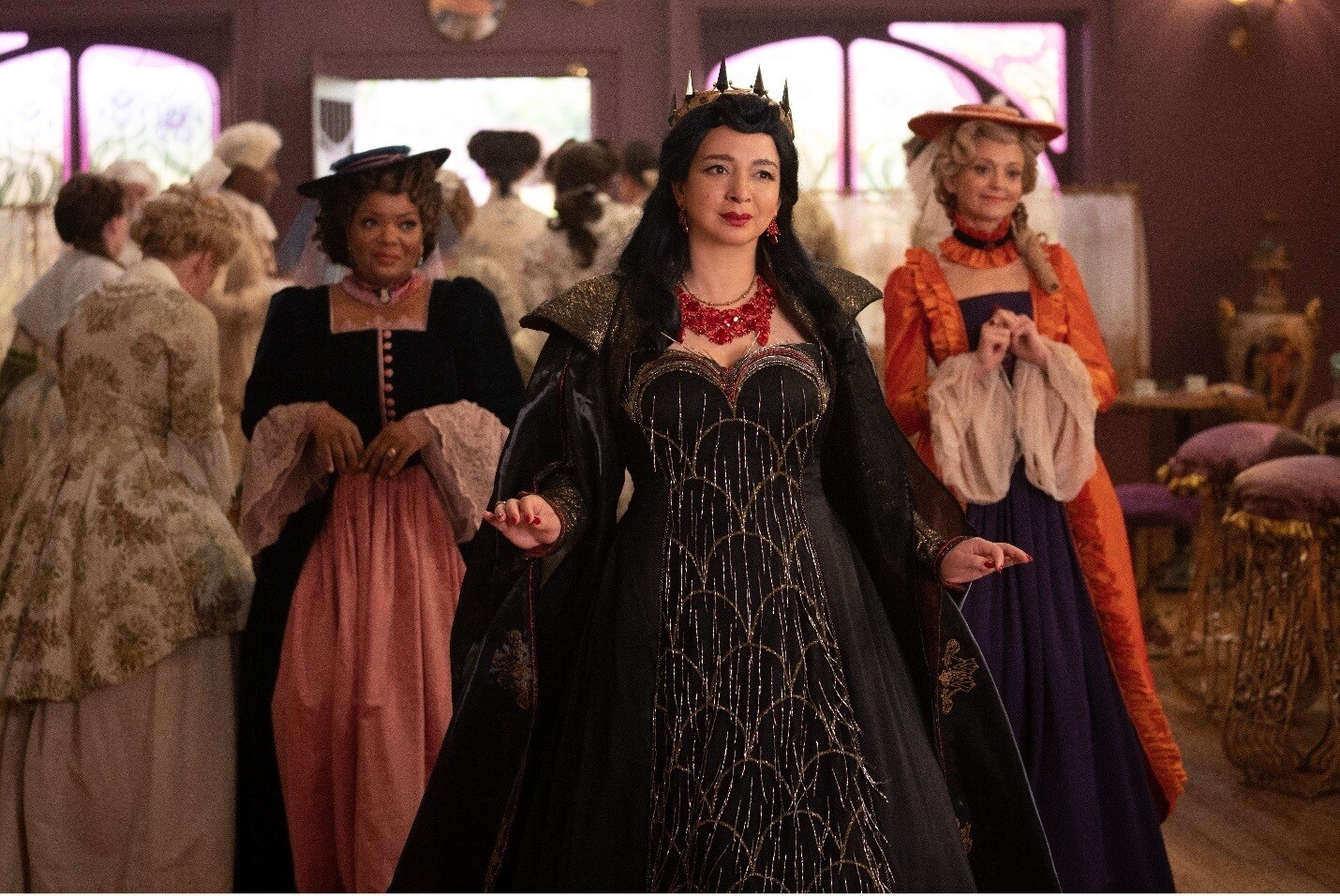 The "Queen" of Monroeville enters with her friends in the Disney+ Original Disenchanted
