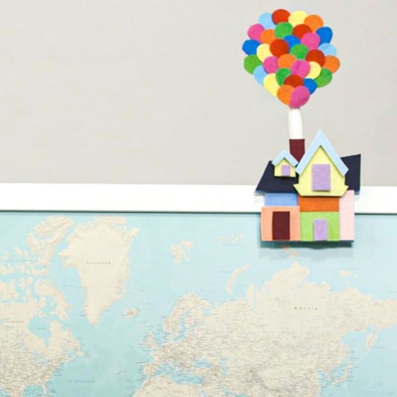 The house from Up made from paper floating above a map