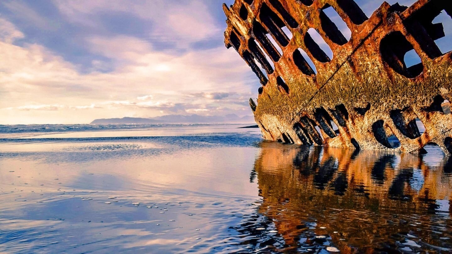 A sunken shipwreck sticking out of the ocean