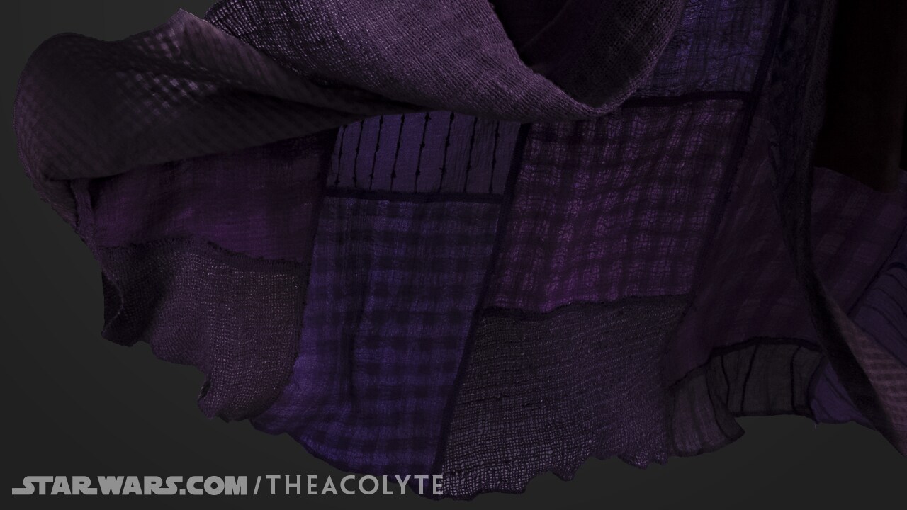 Up close, Mae’s cloak is a patchwork of cotton and gauze squares.