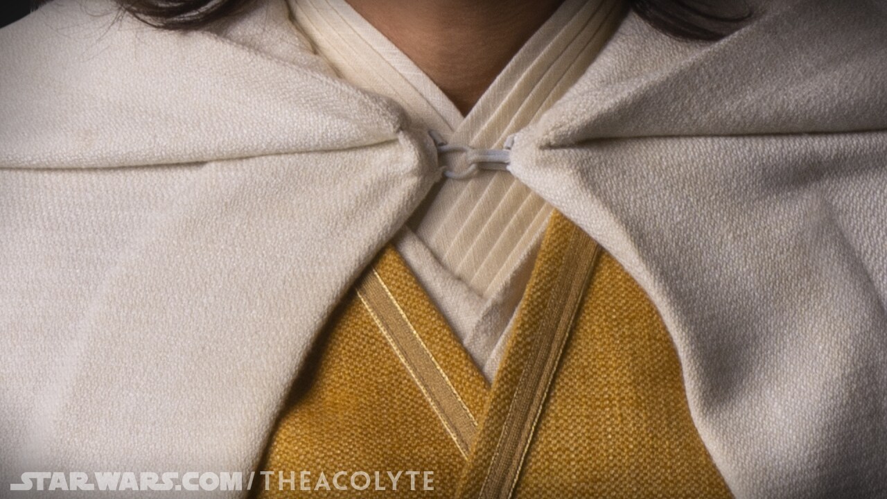 The traditional surplice neckline of Sol’s costume is layered from new materials.