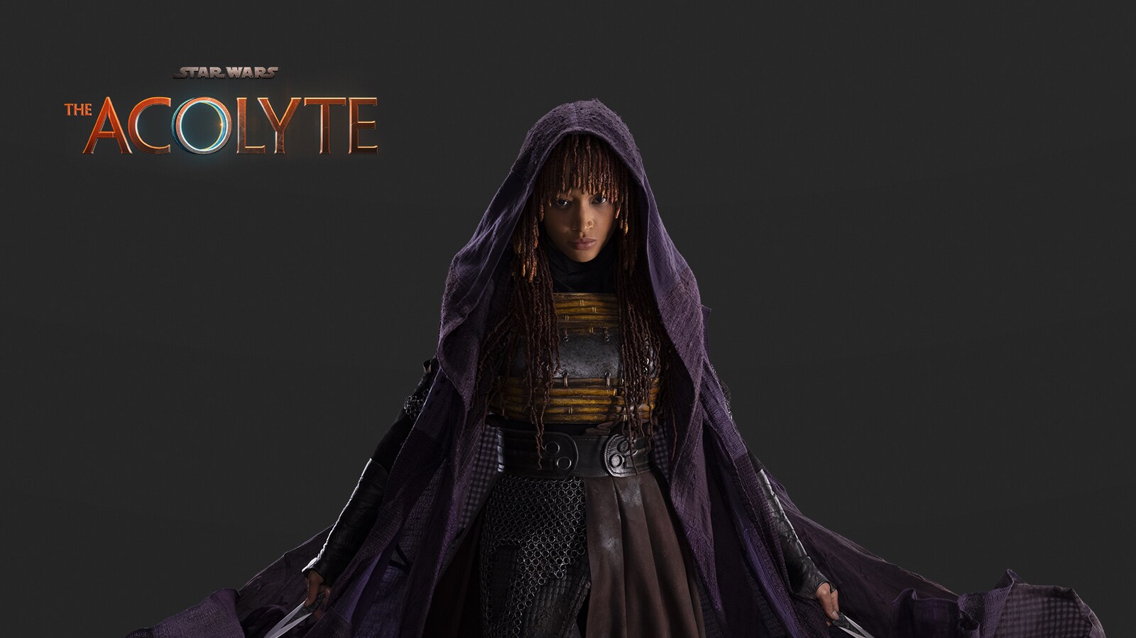 Mae, the assassin, in her traveling cloak.