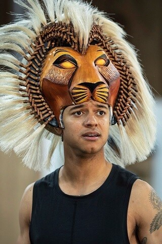 Stephenson Ardern-Sodje wearing the Simba mantle - a headpiece with a lion face.