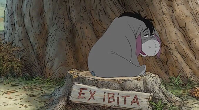 Eeyore sitting on a tree stump with a sign that says "Ex ibita"