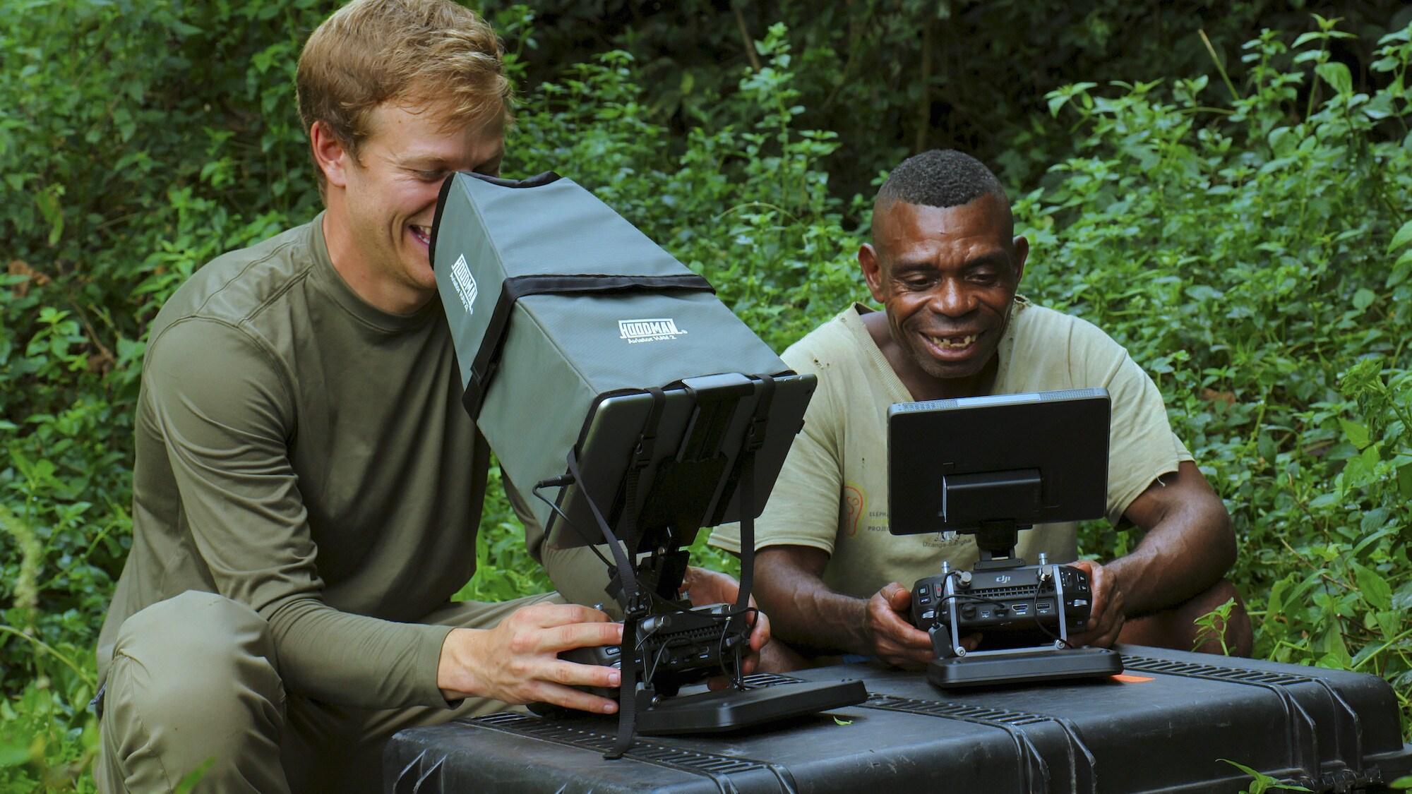 Bertie Gregory and Ngbanda Bathelomie  viewing the drones images when flying. (National Geographic for Disney+/Mark Mclean)