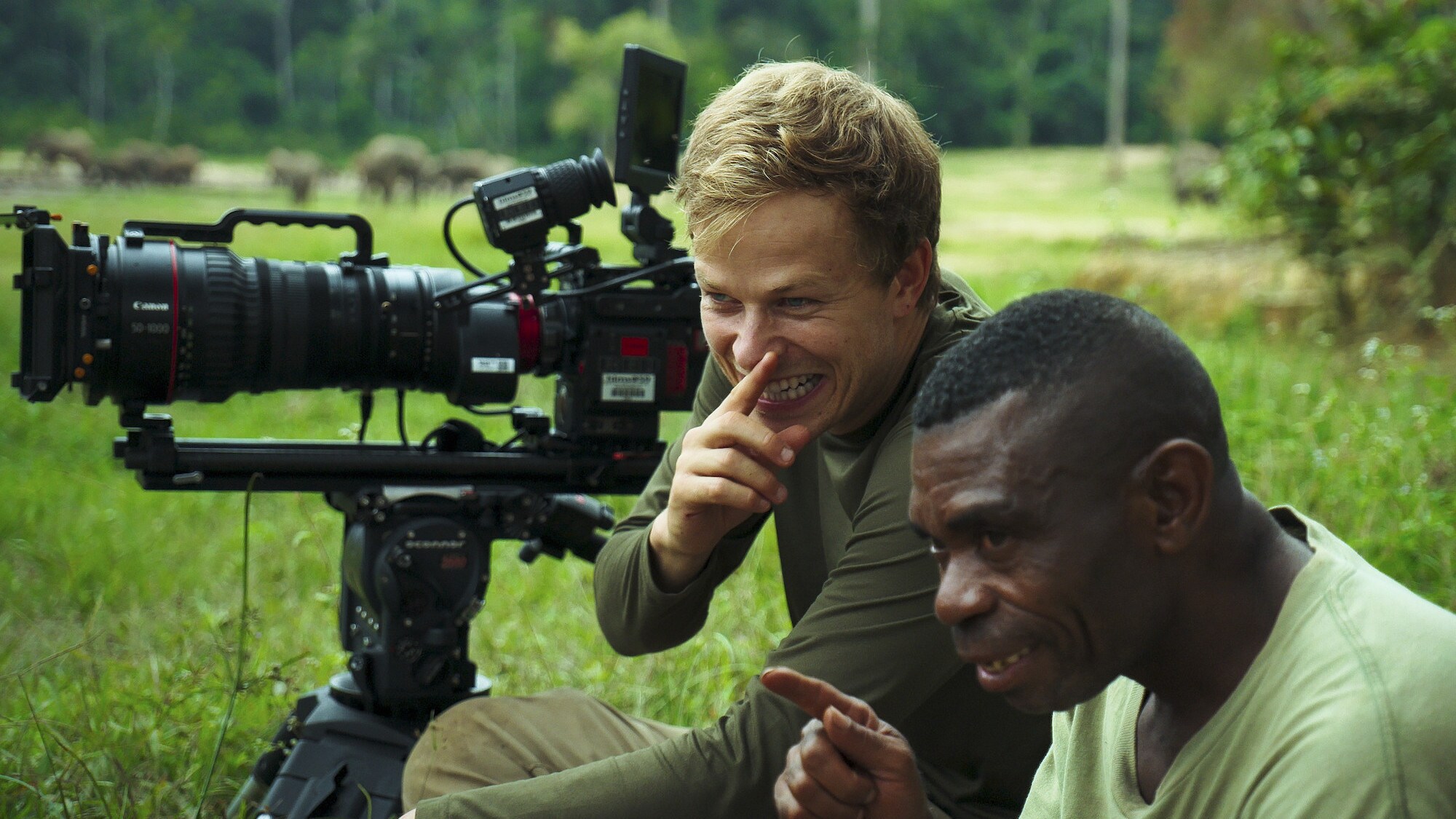 Bertie Gregory and an Ngbanda Bathelomie laughing. (National Geographic for Disney+/Mark Mclean)