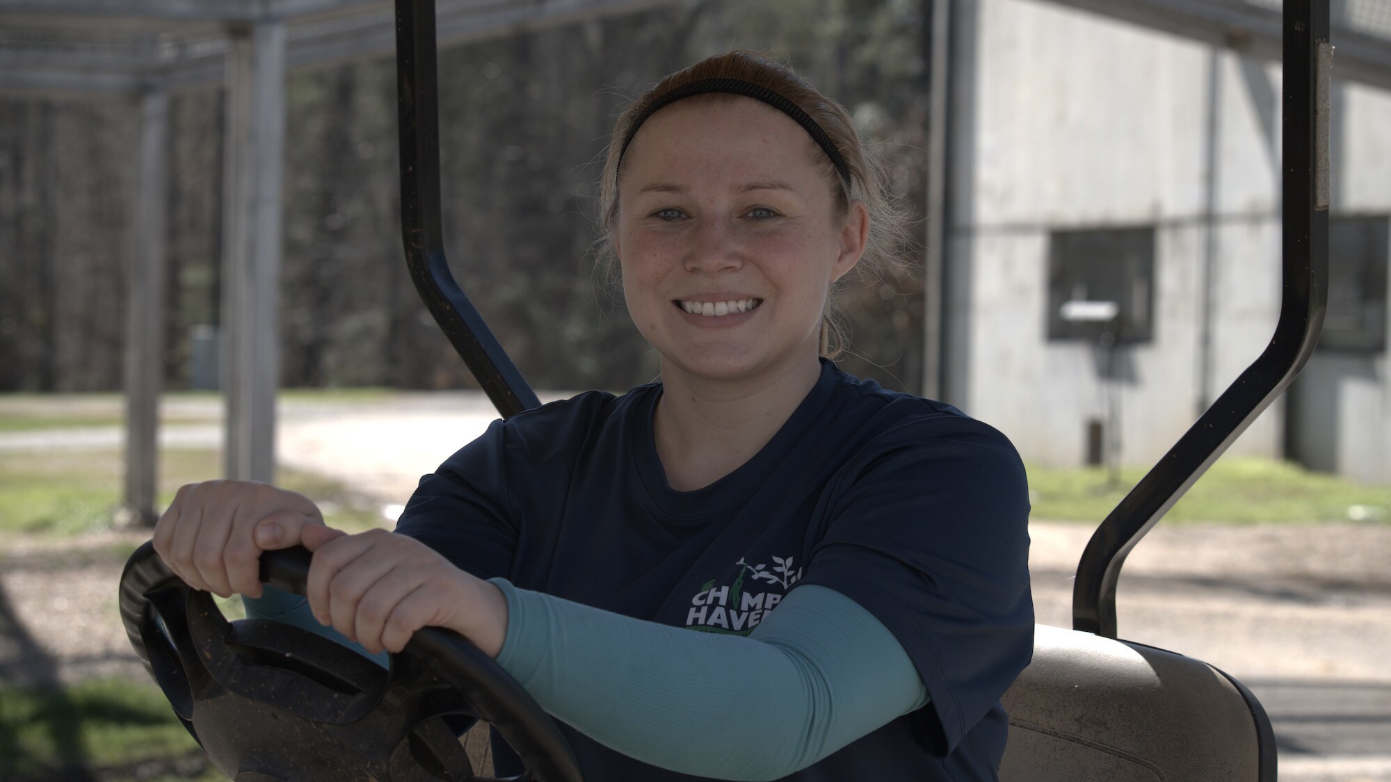 Awbrea Moss, Animal Care Coordinator, driving golf buggy. (National Geographic/Virginia Quinn)