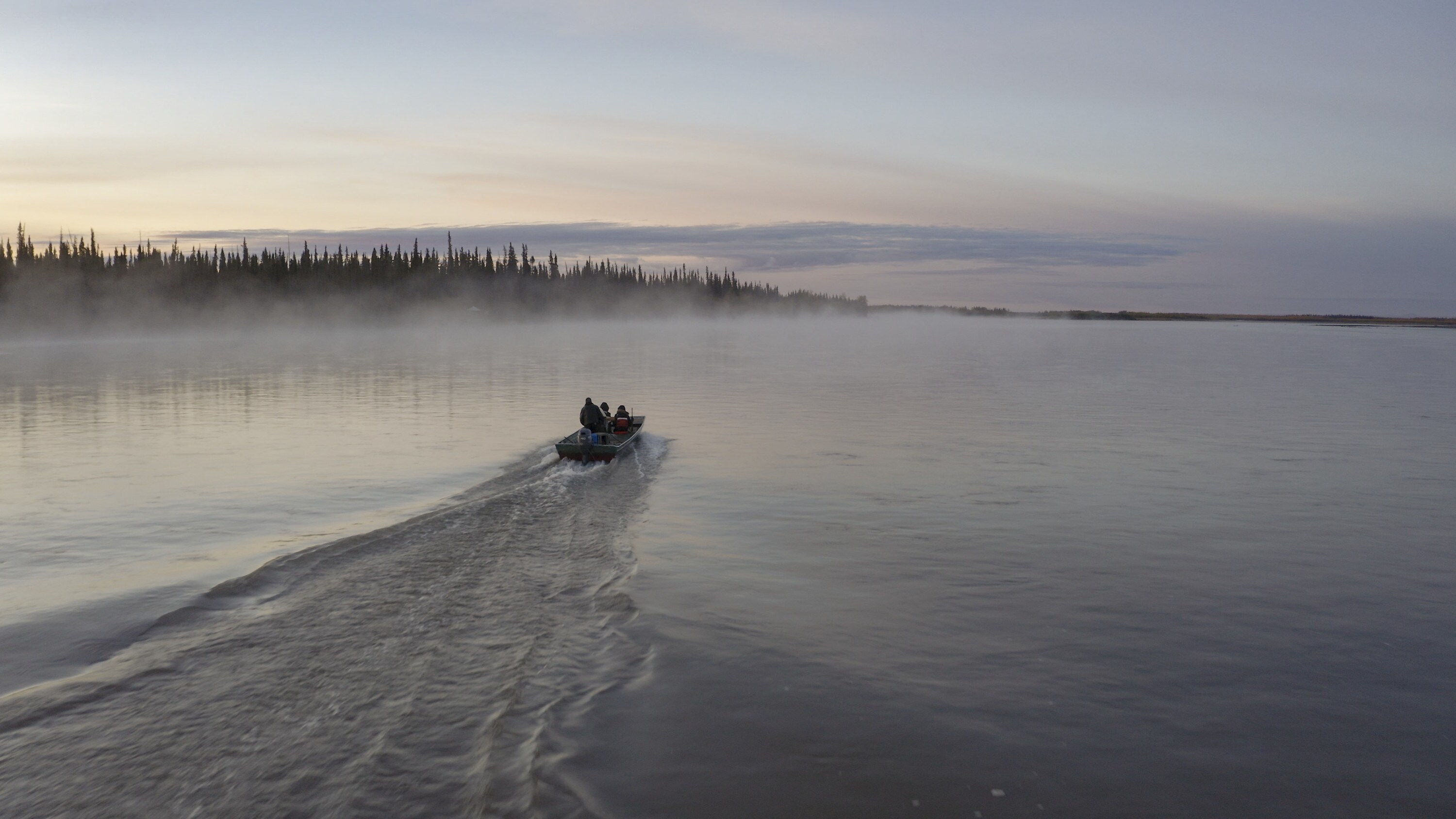 Bernadette Dementieff and her family ride up the Yukon River on their way to their ancestral hunting grounds. (National Geographic/Andrew Thompson)