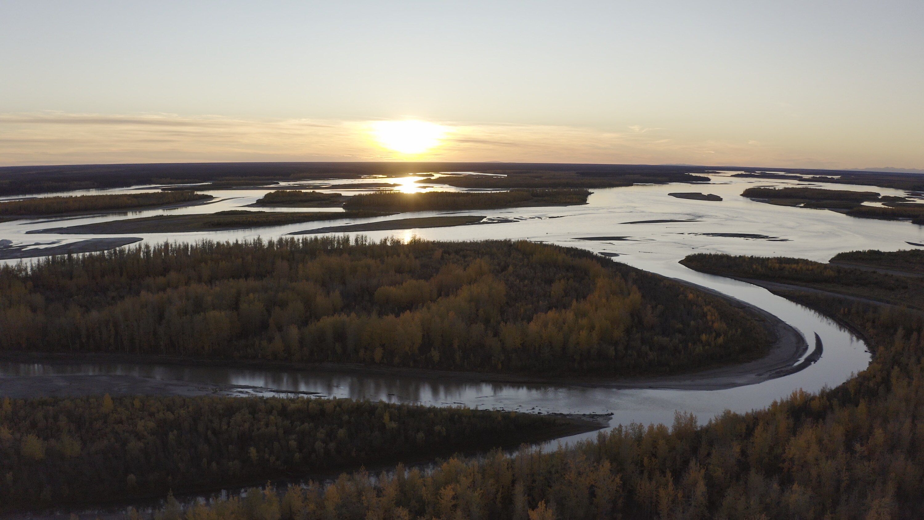The sun reflects on the water of the Yukon flats. These lands are essential for the survival of migratory caribou.  (National Geographic/Austin Ferguson)