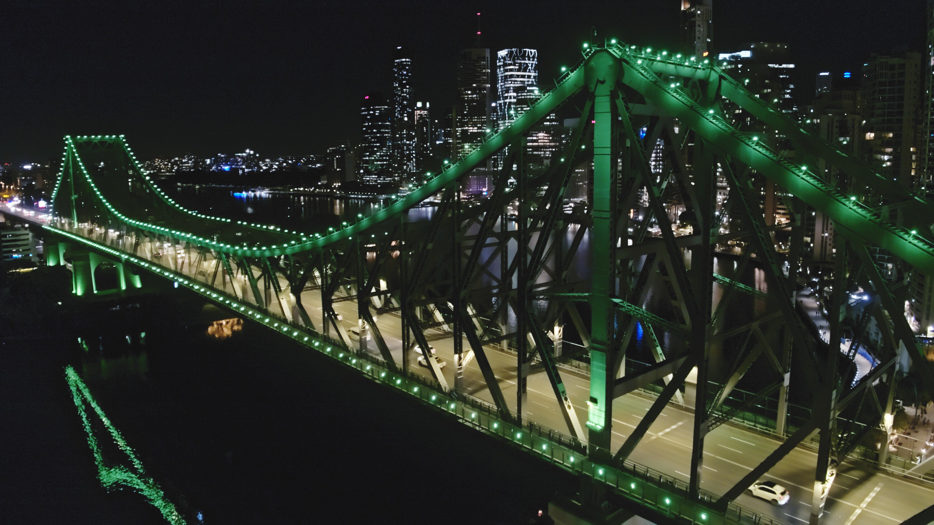 Flying past the green-lit Story Bridge in Brisbane. (National Geographic for Disney+)