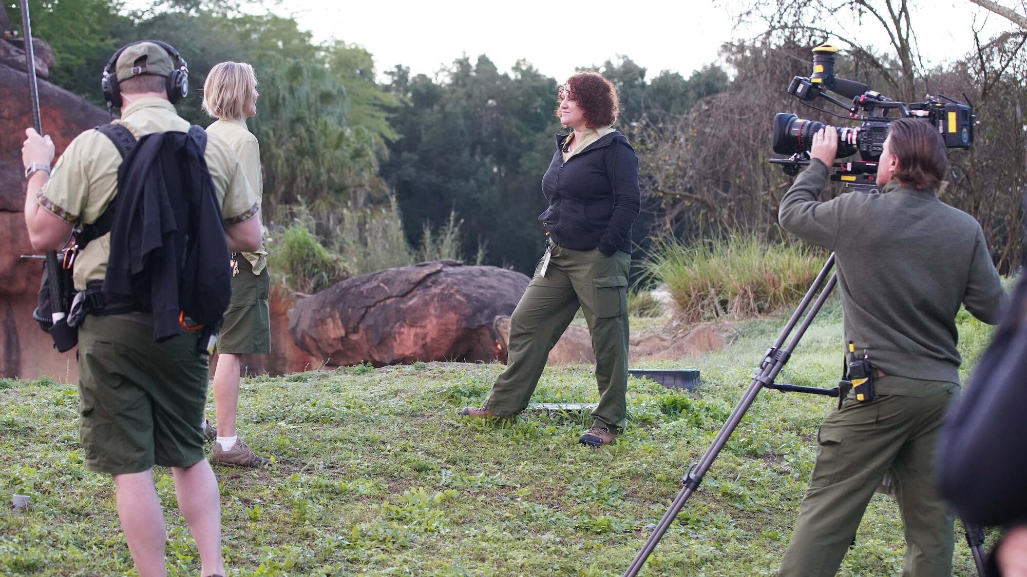 Production team filming keeper on the Savannah of the Kilimanjaro Safari. (Disney)