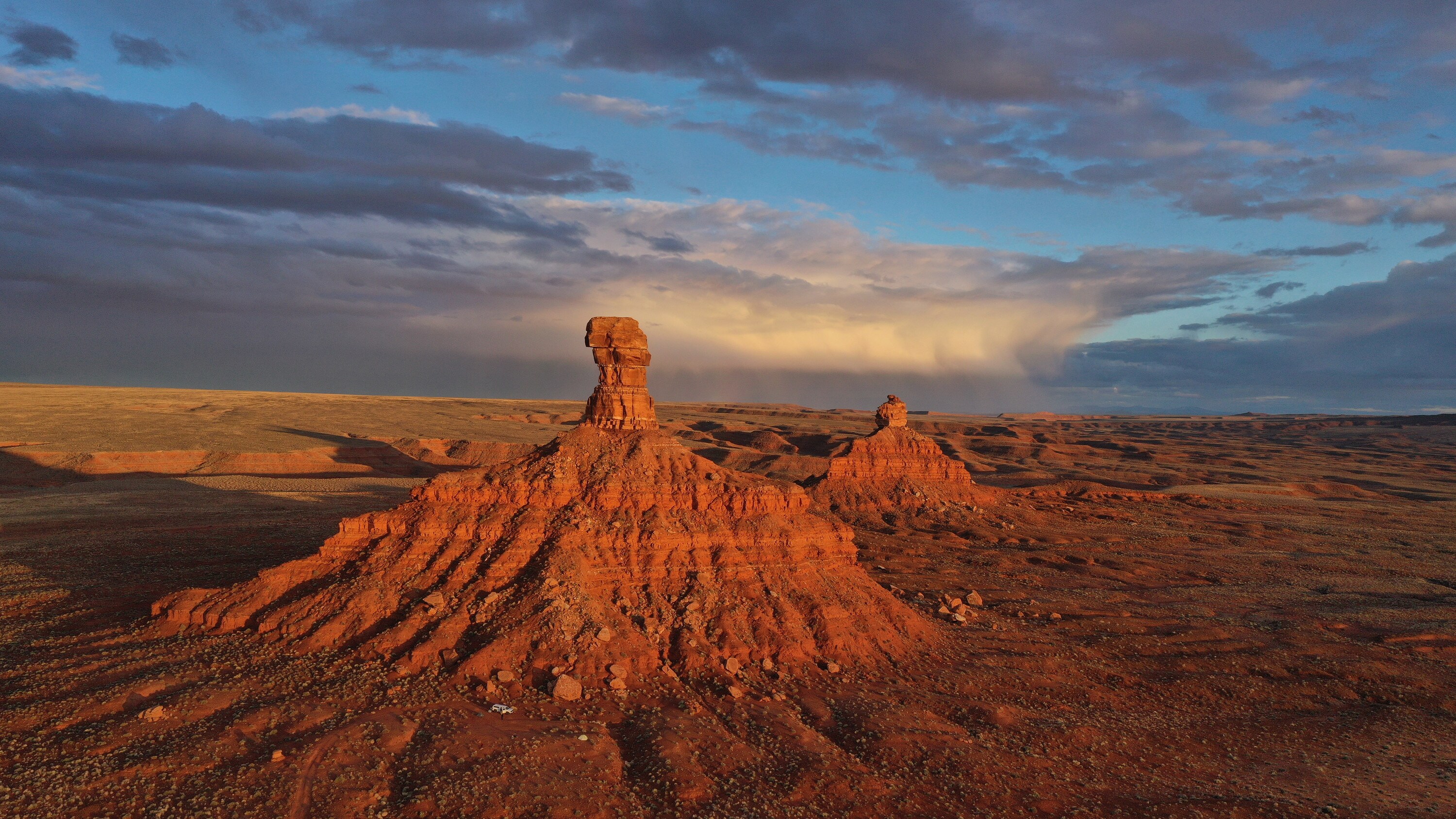 A pair of bluffs painted orange by the setting sun in Valley of the Gods, Utah. (National Geographic for Disney+/Renan Ozturk)