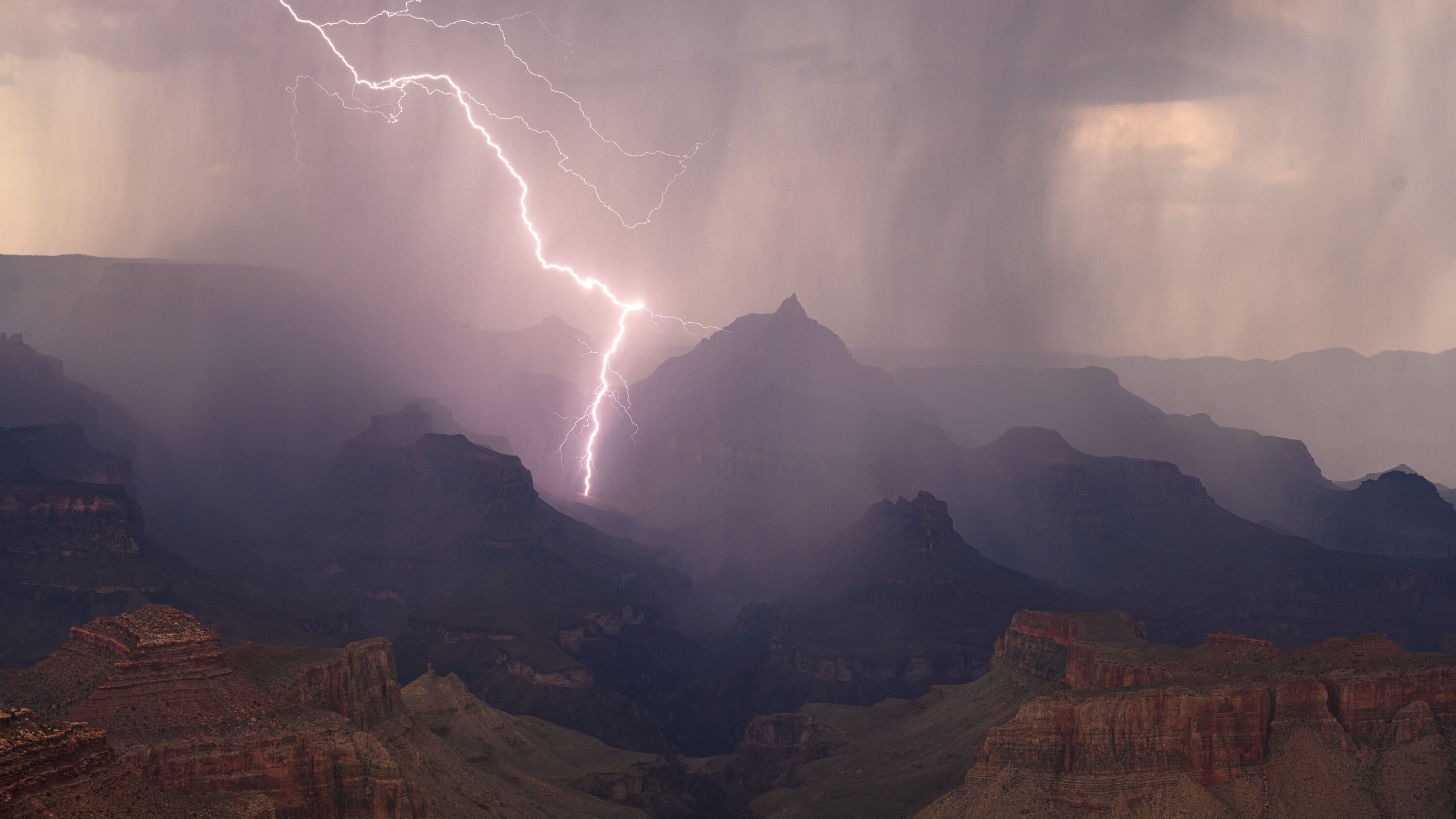 Lightning strikes during a monsoon storm over the Grand Canyon, AZ. (America Films Ltd/Ty Schmitt)