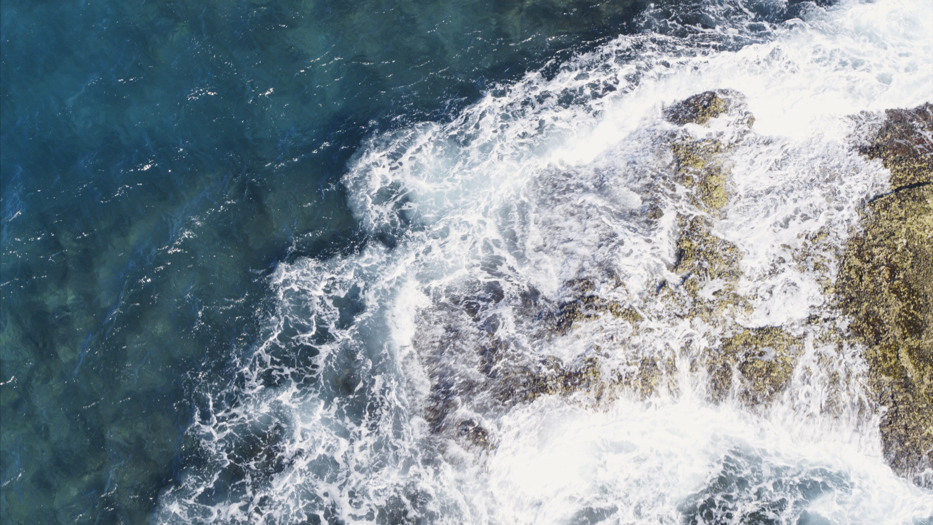 Waves crash on the rocks off of North Stradbroke Island. (National Geographic for Disney+)