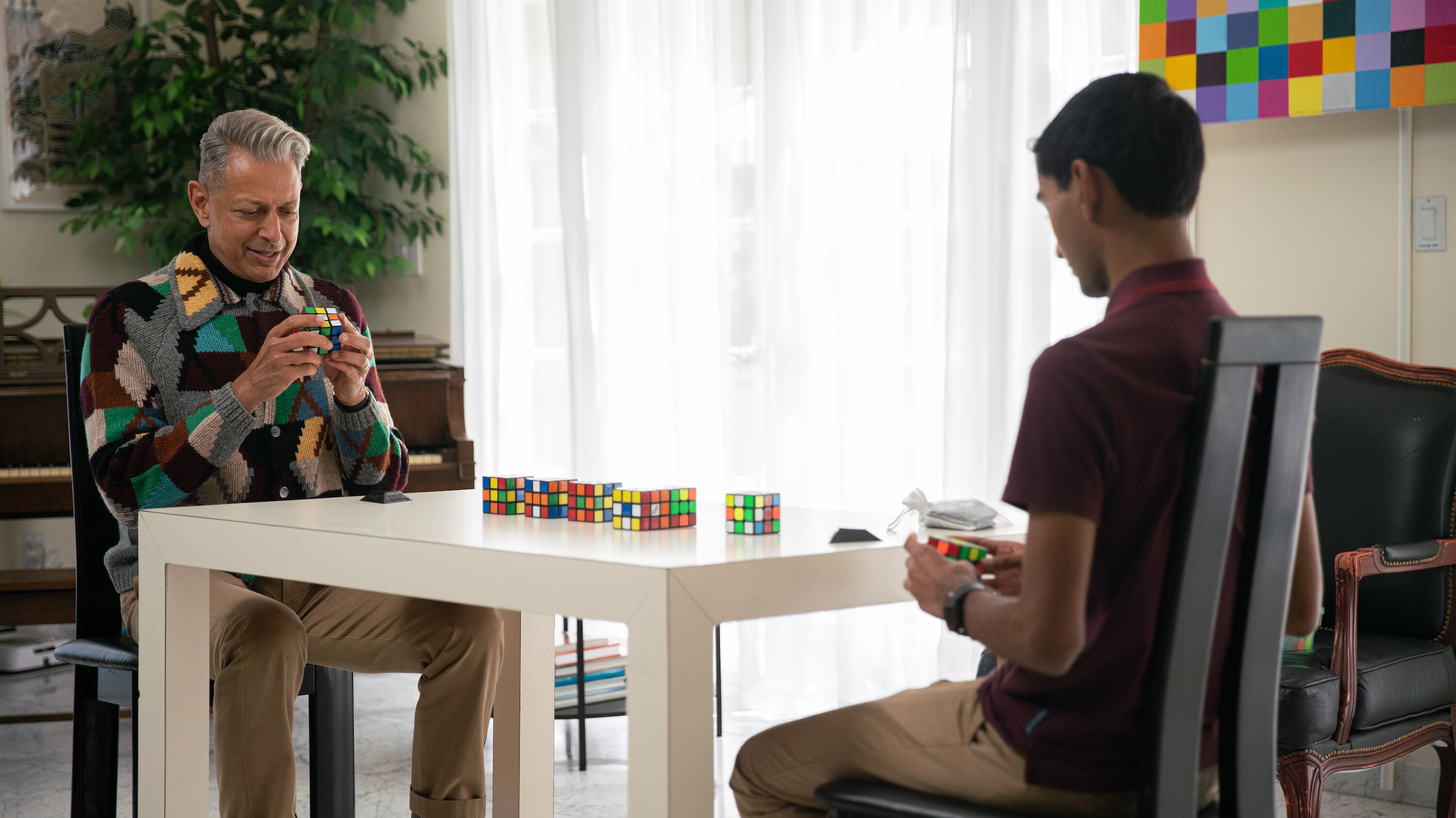 Los Angeles, CA - Jeff Goldblum (L) opposite Rubik's Cube master and several Rubik's Cubes. (Credit: National Geographic)