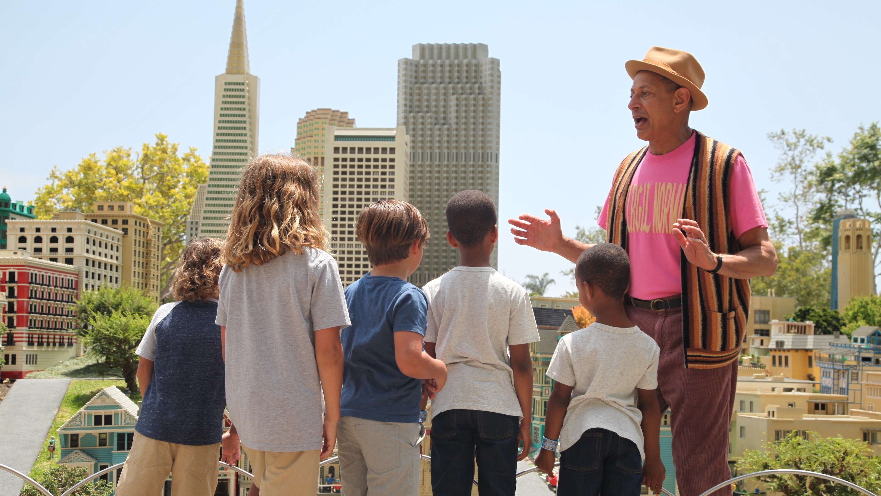 Carlsbad, CA - Jeff Goldblum (R) speaking with children in Legoland City. (Credit: National Geographic)