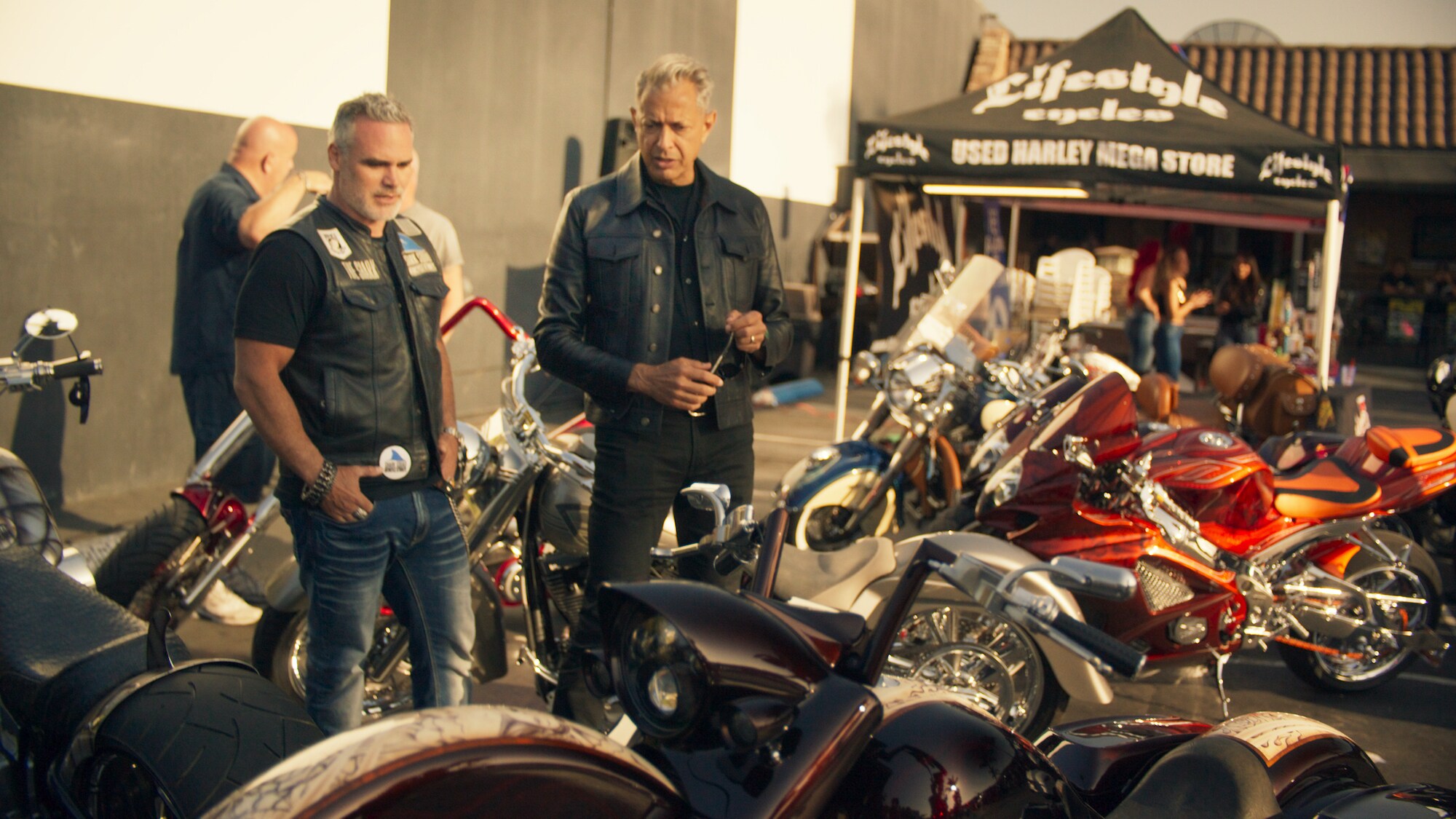 Huntington, CA - Jeff Goldblum (R) talks with a motorcycle enthusiast. (Credit: National Geographic)