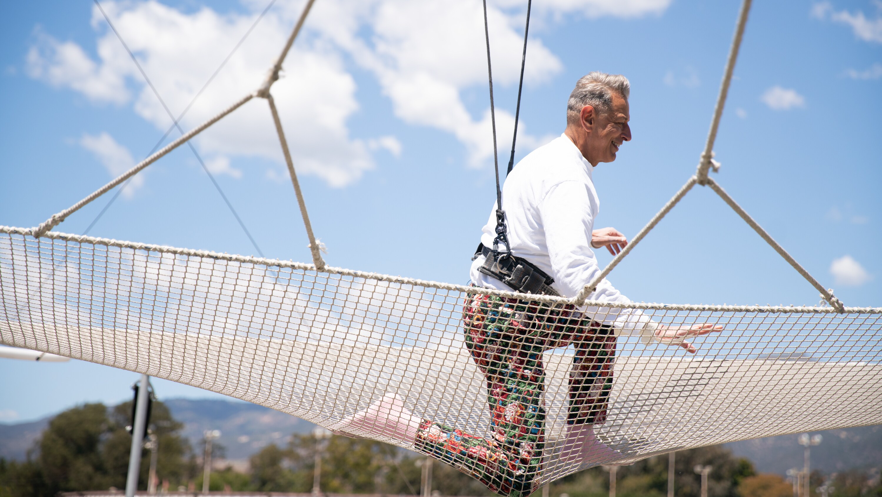 Santa Barbara, CA - Jeff Goldblum on net after swinging on a trapeze. (Credit: National Geographic)
