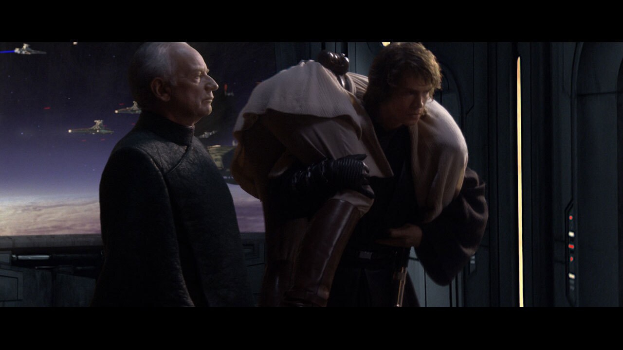 Anakin carries Obi-Wan's unconscious form as he and Chancellor Palpatine attempt to escape the cr...