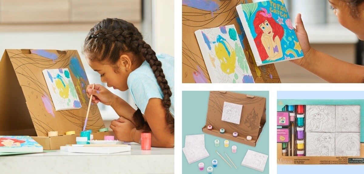 Girl painting a canvas of Flounder, girl holding a painted canvas of Ariel, an easel and paint pots