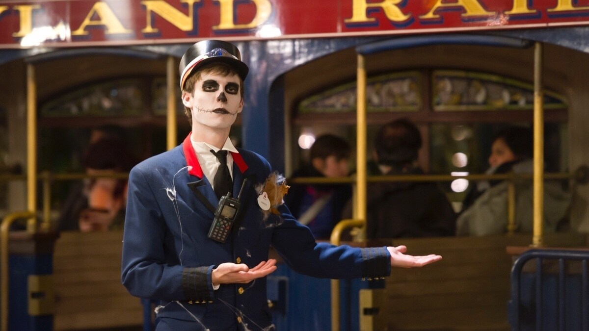 Man dressed as a skeleton train conductor