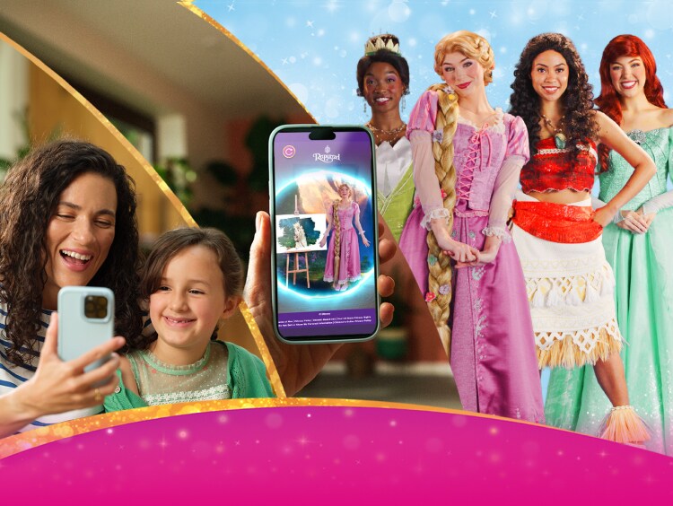 Group of children and adults interacting with a princess-themed mobile app, with fairytale characters and a sparkly pink background.