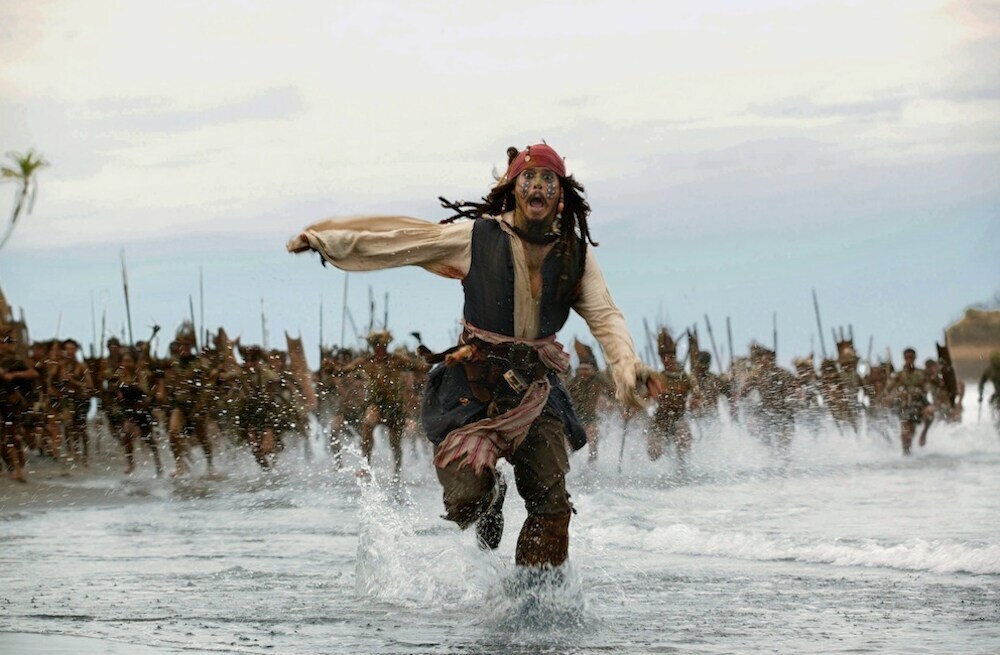 Actor Johnny Depp as Captain Jack Sparrow running from a mob from the movie "Pirates of the Caribbean"