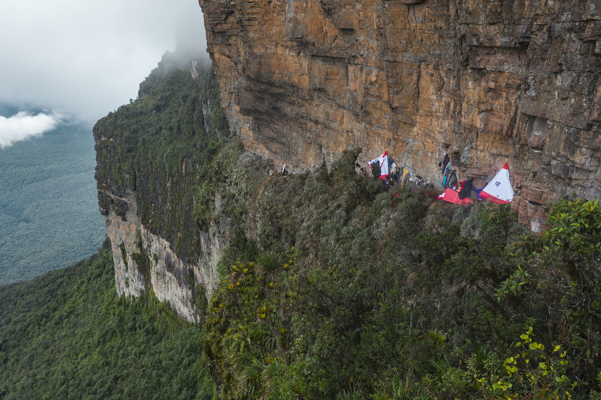 The climbing team is settled into their wall camp at night on a tepui face deep in the Amazon. (National Geographic/Renan Ozturk)