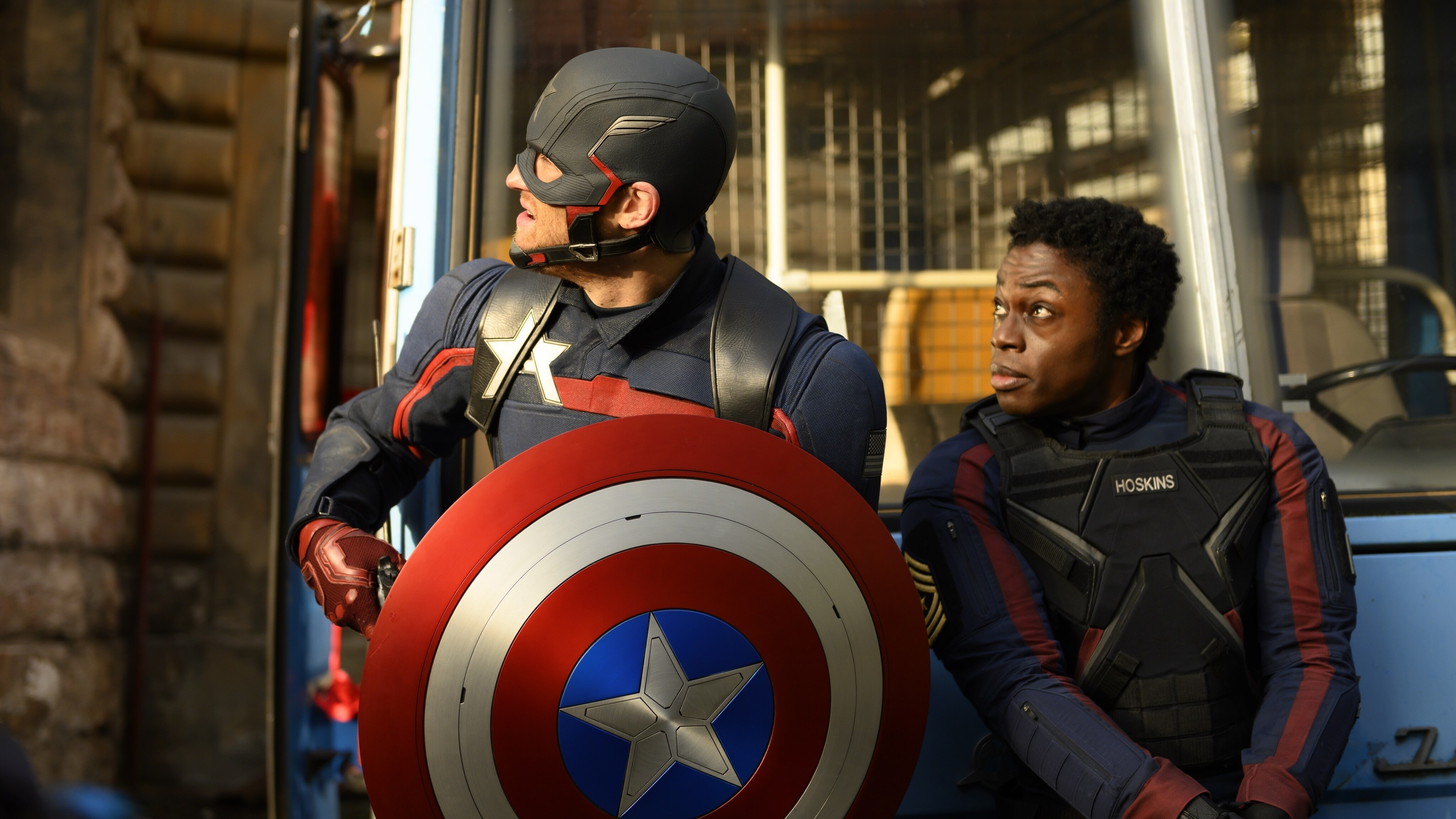(L-R): John Walker (Wyatt Russell) and Lemar Hoskins (Clé Bennett) in Marvel Studios' THE FALCON AND THE WINTER SOLDIER exclusively on Disney+. Photo by Julie Vrabelová. ©Marvel Studios 2021. All Rights Reserved.