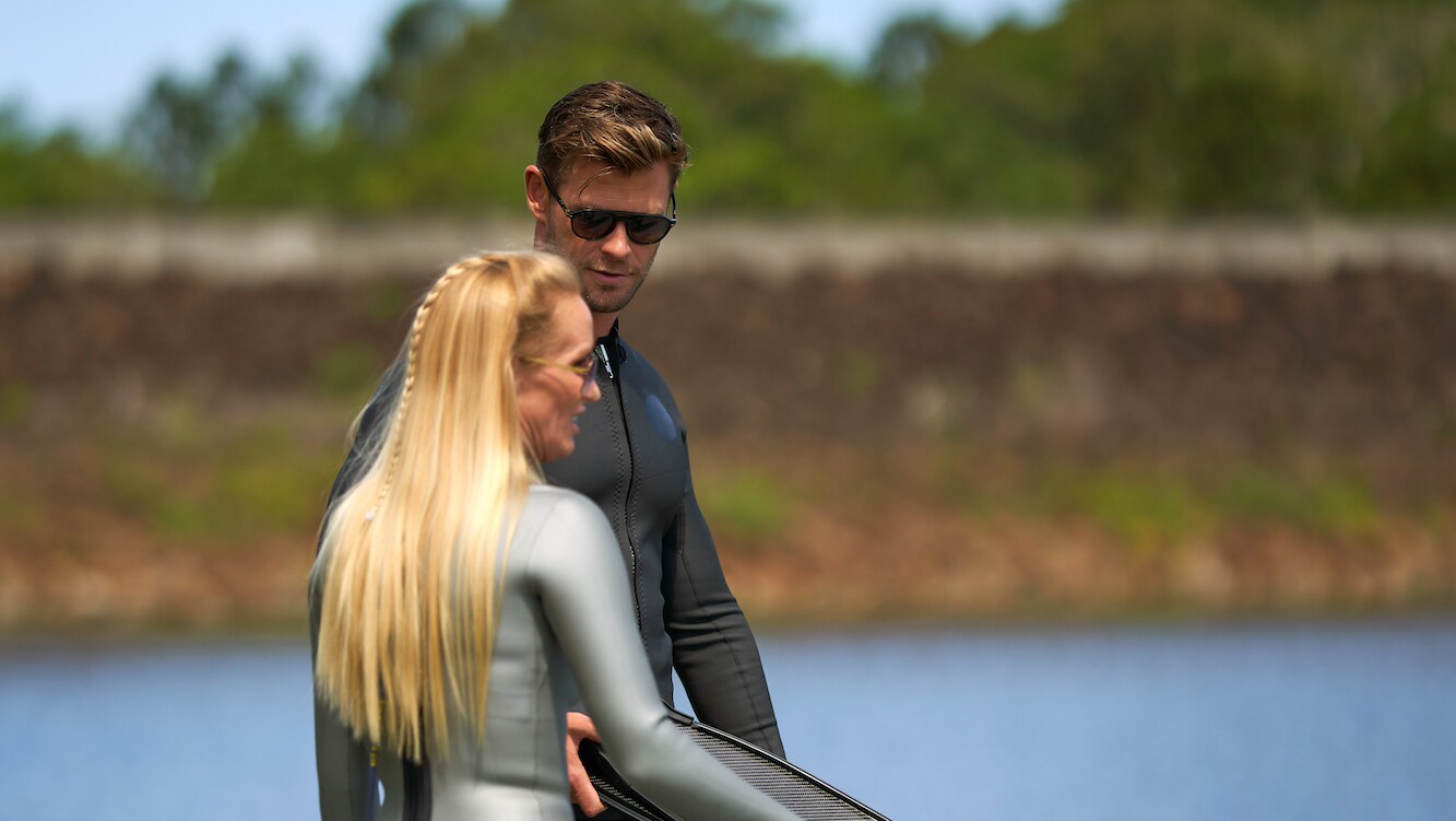 Chris Hemsworth speaks with Tanya Streeter by the water. (National Geographic for Disney+/Craig Parry)