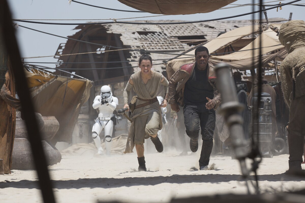 Finn and Rey being pursued by Stormtroopers on Jakku